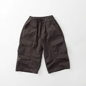 Detailed flat lay of charcoal grey cargo pants featuring elastic waist and large side pockets