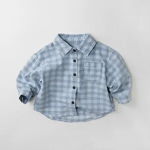 Close-up of kids gingham denim shirt with a square chest pocket and button-down front