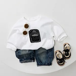 Kids casual spring outfit featuring white long sleeve t-shirt and washed denim jeans