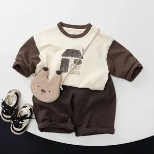 Detail of kids casual raglan long sleeve shirt with matching loose wide-leg trousers