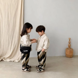Kids' beige cotton long sleeve shirt and striped pants set in modern earthy tones