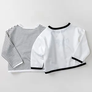 Detailed flat lay of children's cotton striped long sleeve shirts with soft knit texture
