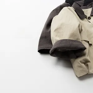 Detail of kids two-tone collared jacket showing cotton linen texture and fine stitching