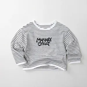 Detail of soft cotton kids' striped long sleeve shirt with MONDAY GREAT print