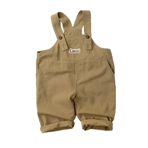 Toddler khaki cotton overalls with Luck! print and adjustable straps on white background