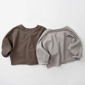 Detail of soft cotton kids sweatshirts showing raw edge hems and trendy drop shoulders