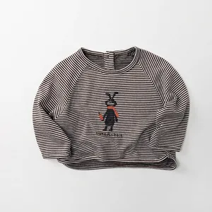 Close-up of children's striped tee with a cute cartoon rabbit and back button collar
