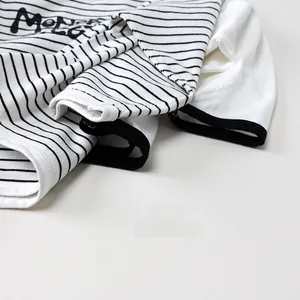 Close-up of black and white striped cotton fabric with Monday print and hemmed cuffs