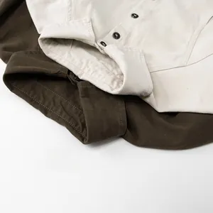 Detail view of cotton shirts with standard collars and contrasting black buttons