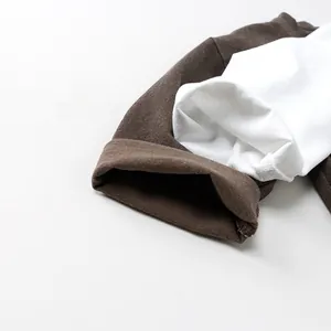 Macro shot of cotton knit cuffs in dark brown and beige for kids basic T-shirt
