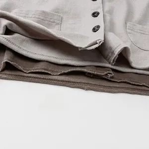 Detail view of cotton knit cardigan featuring round buttons and premium double stitching