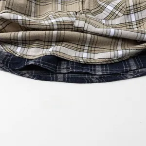 Détail de l'ourlet de chemise à carreaux marron et bleu avec coutures en flanelle
