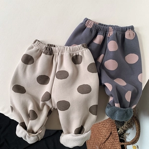 Close-up of thick fleece lining and polka dot pattern on warm toddler winter pants