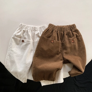 Detailed view of elastic waist and back pocket on corduroy pants for children