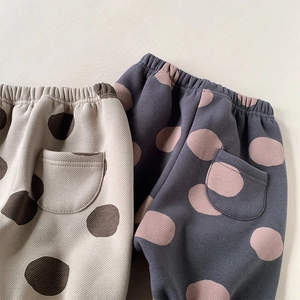 Detail of waffle knit texture and elastic waist on polka dot fleece lined toddler pants