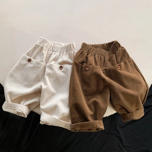 Detailed view of corduroy texture and button pockets on kids casual elastic waist pants