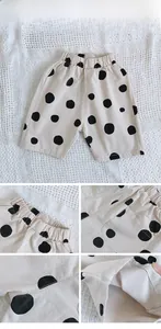 Detailed views of kids polka dot cotton shorts showing elastic waist and side pockets