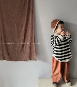 Detail of girls striped long sleeve t-shirt and wide leg pants in a minimalist retro style