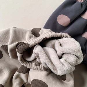 Detail of warm fleece lining and elastic waistband on toddler polka dot winter pants