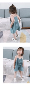 Close-up of baby girl sleeveless romper with star patterns and button details