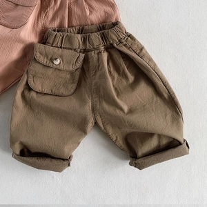 Detail view of cotton kids casual pants featuring elastic waist and large flap pocket
