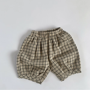 Detailed close-up of breathable linen plaid shorts for kids featuring elastic waistband