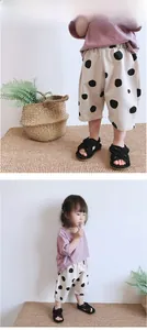 Detailed model show of toddler girls beige polka dot shorts with black woven sandals