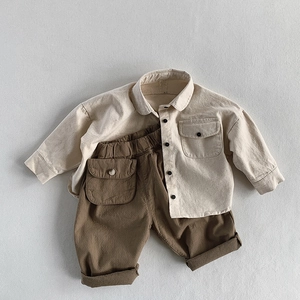 Close-up of children's cotton cargo pants showing elastic waist and side flap pocket details