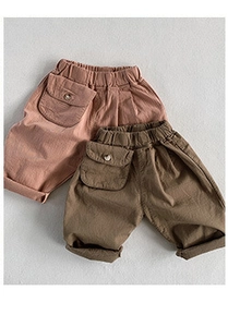 Detail of elastic waist and utility pockets on cotton-linen blend kids casual pants