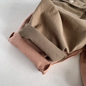 Kids casual loose cotton trousers in khaki and pink colors with rolled cuff details