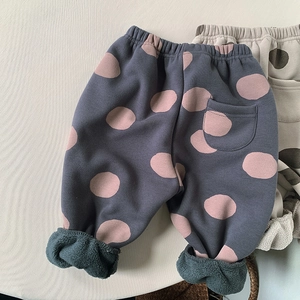 Detail of fleece-lined kids' polka dot pants showing warm interior and elastic waist