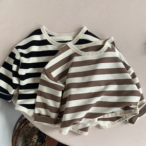 Detail view of cotton striped long sleeve shirts in black and brown colors for kids