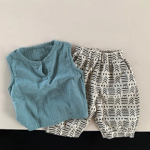 Detail of kids linen tank top with V-neck and ethnic pattern elastic waistband pants