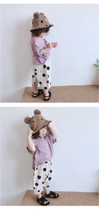 Detail of toddler girl summer outfit with heart embroidery and polka dot wide pants