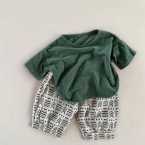 Detailed flat lay of children's cotton linen summer t-shirt and patterned bloomers set