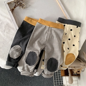 Detailed flat lay of three pairs of cotton baby leggings with stripes and polka dot patterns