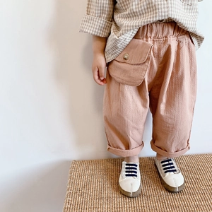 Detail of toddler cotton linen pants featuring elastic waist and decorative large pocket