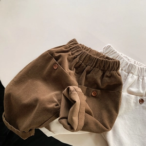 Detail view of children's corduroy trousers with elastic waist and large pockets