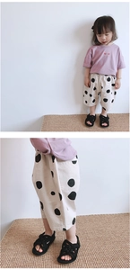 Detail view of toddler girl summer set featuring polka dot wide-leg pants and cotton tee