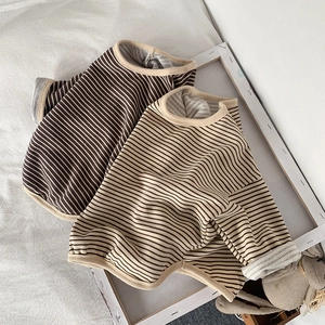 Detail of soft ribbed cuffs and neckline on striped knit cotton long-sleeve shirts