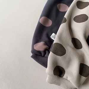 Close-up of warm knitted polka dot pants with thick elastic ribbed cuffs for toddlers