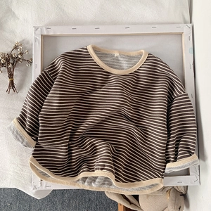Close-up of kids striped sweatshirt with ribbed cuffs and warm textured cotton fabric