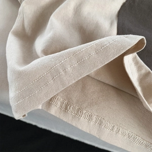 Close-up of dual-needle stitching and interlocking seam on girls' cotton t-shirt hem