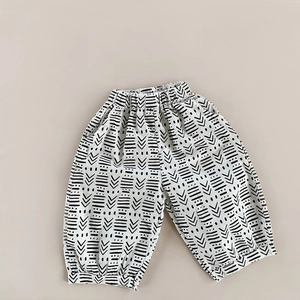 Detailed flat lay of toddler cotton harem pants featuring black and white geometric stripes