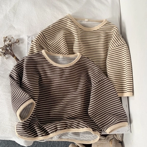 Flat lay of soft striped cotton long-sleeved t-shirts with ribbed crew neck details