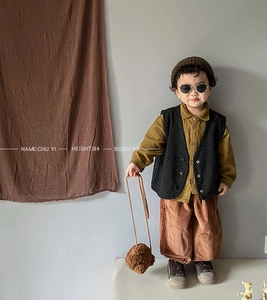 Detailed view of child's autumn outfit with corduroy wide leg pants and model size info