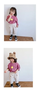 Detail of toddler corduroy trousers with elastic waist and matching sun print cotton shirt