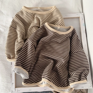 Close-up of ribbed crewneck and soft cotton texture on kids striped long sleeve shirts