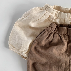 Detail of high elastic waistband and cotton linen texture on kids loose bloomer shorts