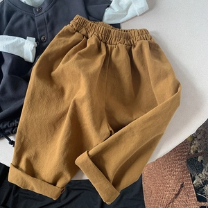 Kids minimalist loose cotton pants in mustard yellow with elastic waist and rolled cuffs